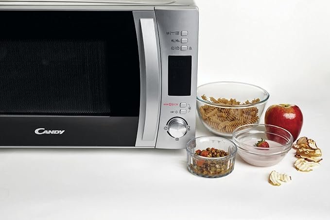 Microondas Candy CMXG20DS con grill y tecnología Cook in App, capacidad de 20 litros, diseño moderno en acero inoxidable, ideal para calentar, cocinar y gratinar alimentos de forma eficiente.