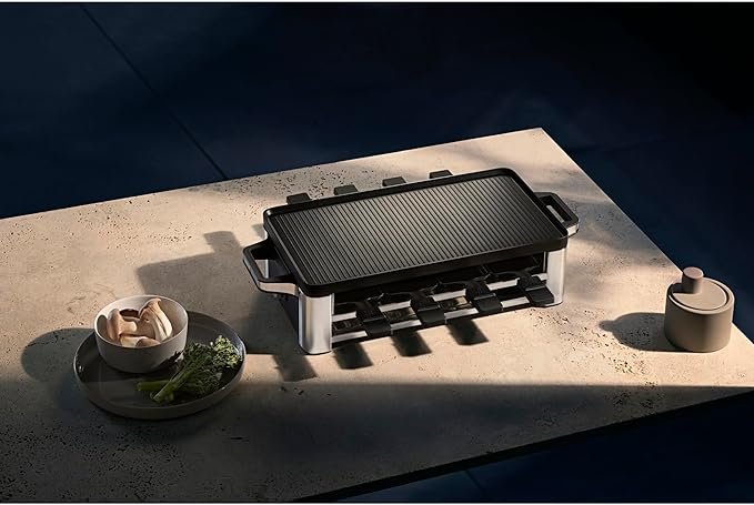 Imagen de la WMF Lono - Parrilla Raclette y grill de 1500 W, mostrando su diseño elegante en acero inoxidable, superficie antiadherente y controles intuitivos, ideal para resaltar en las opiniones sobre su rendimiento y calidad.